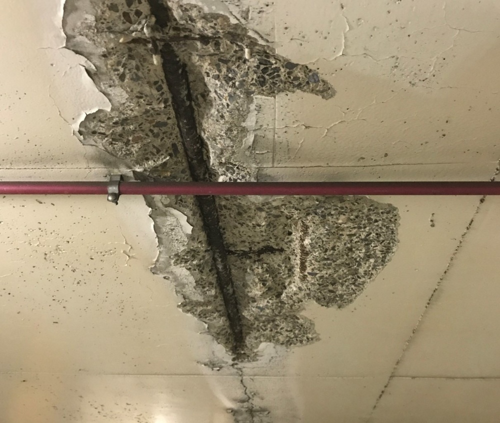 Spalling concrete on Garage Ceiling. Signs of corrosion are evident with rusting rebar visible.